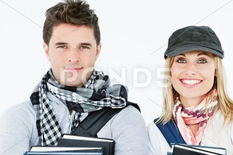 Portraits of two students holding books and smiling at the camera Stock Photos