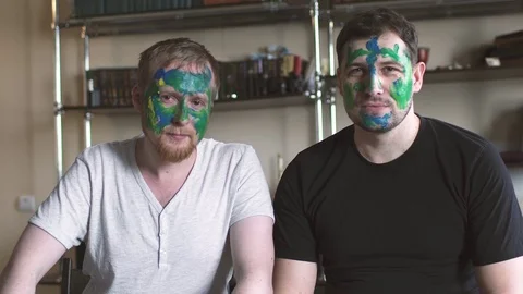 Portraits of two young fathers, whose faces were painted by children in bright Stock Footage 74365135