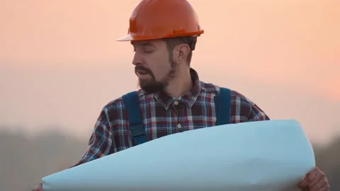 Portrat man builder architect reading draft in field look around. Engineer Stock Footage 169807652