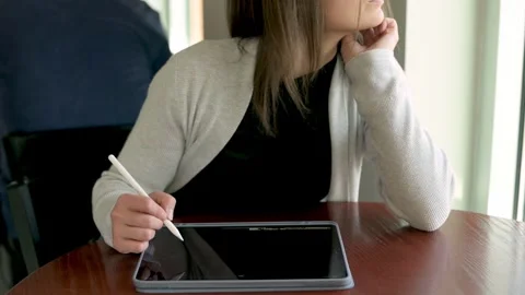 Portrays a designer deep in thought while reviewing digital concepts on a tab Video stock 274516711