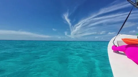 Portside low-angle from a speeding motorboat cruising the clear turquoise Stock Footage 340845522