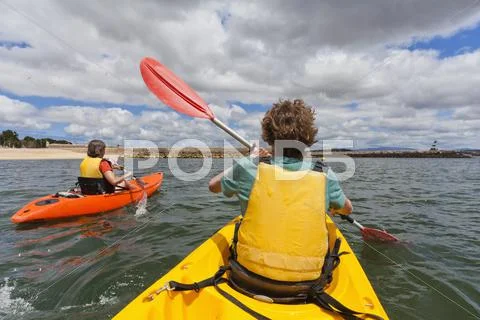 Portugal, lagos, teenage boy mature women rowing kayak Stock Photos