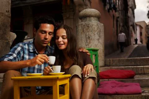 Portugal, Lisboa, Bairro Alto, young couple sitting at street cafe at dusk Stock Photos