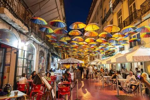  PORTUGAL LISBON BAIXA NIGHTLIFE rainbow Umbrellas at the Party Street of ... Stock Photos