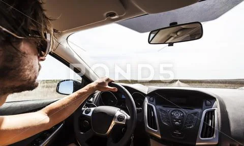 Portugal, Young man driving car on road Stock Photos