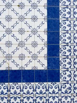 Portuguese azulejos pattern featuring white tiles with intricate blue flora.. Stock Photos