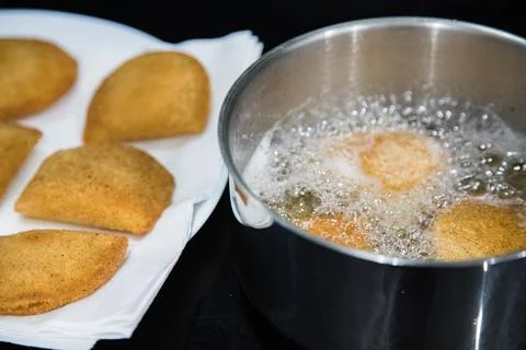 Portuguese rissois being fried in hot oil Stock Photos