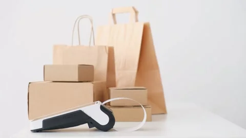POS payment terminal printing out receipt with shopping bags and boxes on white Stock Footage 265803423