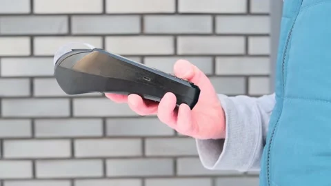 Pos terminal in the hand of a man. Stock Footage 150223229
