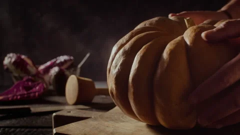 Pose and take a pumpkin on a table Stock Footage 135012410