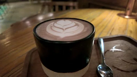 A 'Posh' Coffee with a Leaf Pattern on a Wooden Tray. Stock Footage 294476539