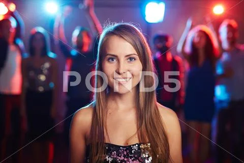 Posh girl with long hair looking at camera at party Stock Photos