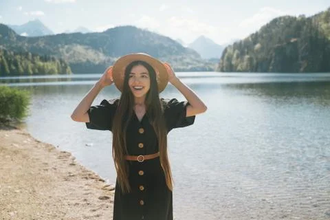 Posing on camera in the background lake and mountains Stock Photos
