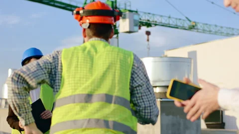 Posing on the construction site engineer lady and businessman at the end of the Stock Footage 143159807