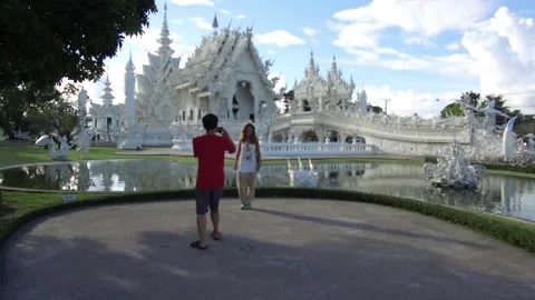 Posing in front of Wat Rong Khun, White Temple, Chiang Rai, Thailand Stock Footage 130697785