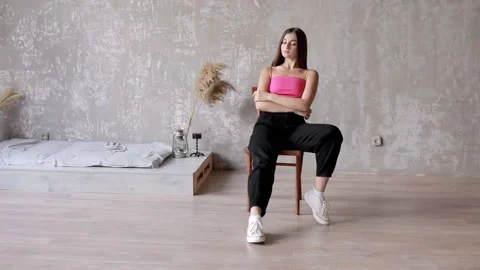Posing middle eastern model posing for the camera in the studio on a chair. Stock Footage 228651341
