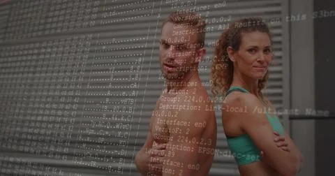 Posing pair back-to-back in gym, woman in teal-bra, man in shorts, code overlay 스톡 사진