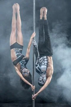 Posing of pole dance couple in dark studio 스톡 사진