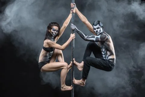 Posing of pole dance couple in dark studio Stock-Fotos