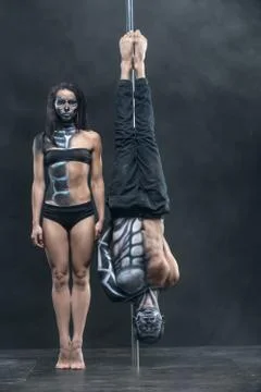 Posing of pole dance couple in dark studio 스톡 사진