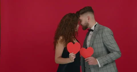 Posing on red background and holding heart. Love concept. Stock Footage 147120050