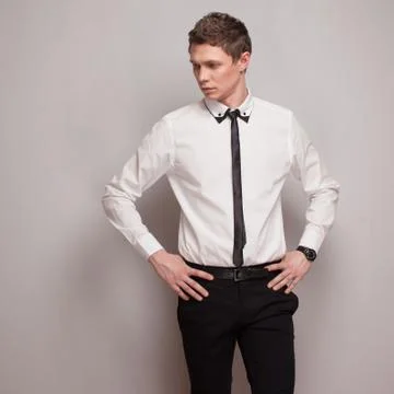 Posing young man model in black and white clothing Stock Photos