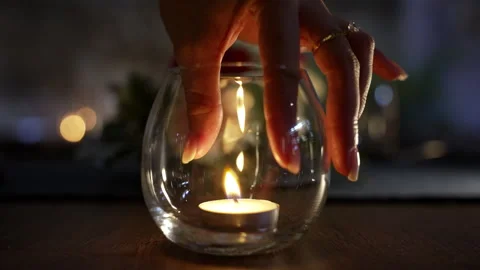 Positioning a candle inside a glass_4K Stock Footage 303427397