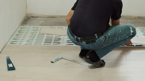 Positioning Laminate Plank on Underlayment Stock Footage 321750126