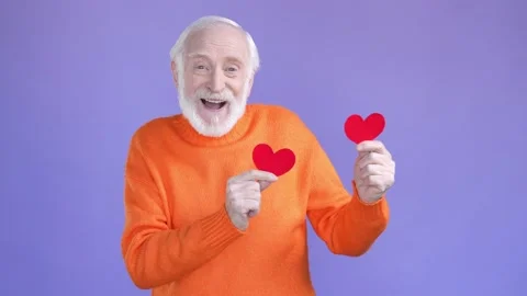 Positive aged man dancing small card hearts isolated vivid color background Stock Footage 188438853