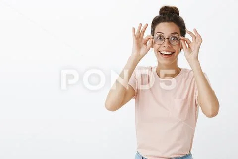 Positive and charismatic good-looking young european female student putting on Stock Photos