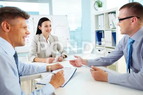 Positive and successful team working harmoniously at office Stock Photos