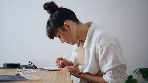 Positive artist sketching notebook at re... | Stock Video | Pond5