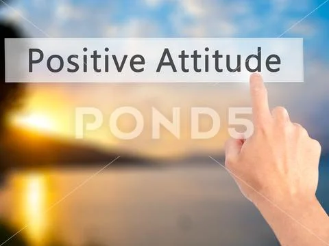 Positive Attitude - Hand pressing a button on blurred background Stock Photos