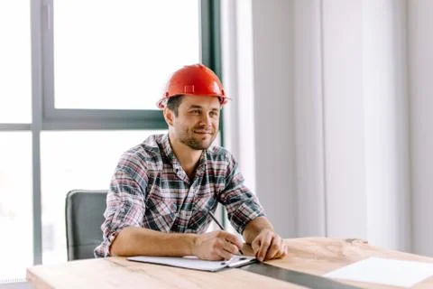 Positive beaded constructor making notes in the notepad Stock Photos