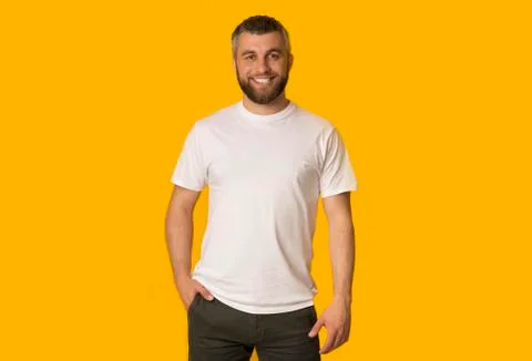 Positive bearded man posing over yellow background Stock Photos