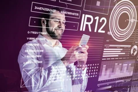 Positive bearded programmer reading messages and smiling Stock Photos
