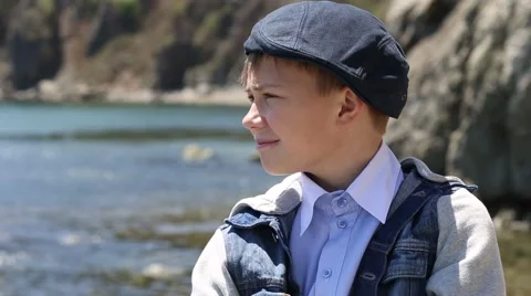 Positive boy smiling and looking at the sea Video stock 49922243