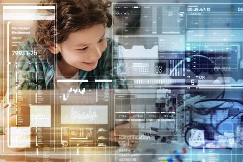 Positive boy smiling while admiring his progressive robot Foto stock