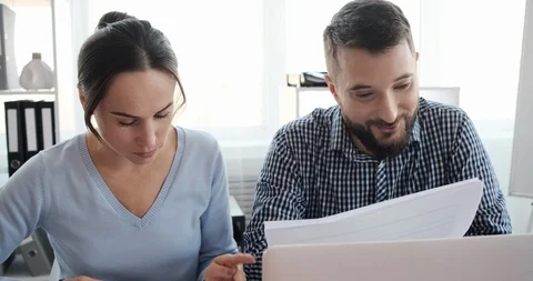 Positive business colleagues analyzing documents at office Video stock 120931043