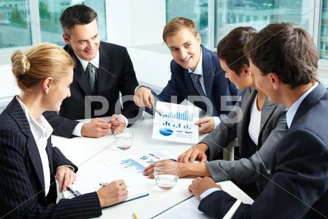 Positive business people holding a meeting to sum up the results of the year Stock-Fotos