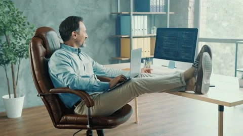 Positive busy freelancer typing pc look monitor hold laptop check report Stock Footage 161403851