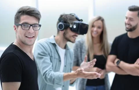 Positive colleagues testing virtual reality glasses Foto stock