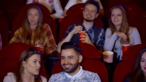 Positive couple drinking cola and eating popcorn in cinema Stock Footage 75037774