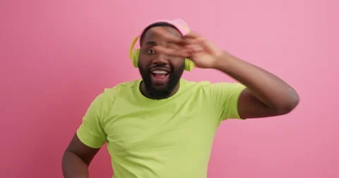 Positive dark skinned bearded guy has fun dances carefree makes disco sign Stock Footage 150297232