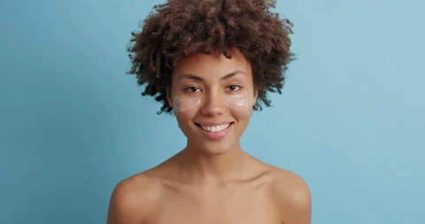 Positive dark skinned curly young woman with naked body smiles positively has Stock Footage 144455013