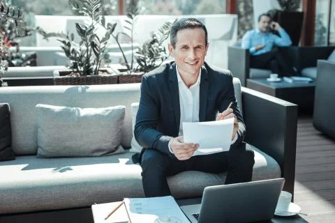 Positive delighted man posing on camera Stock Photos