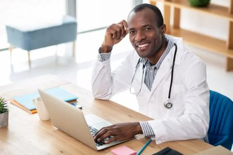 Positive delighted practitioner posing on camera Stock Photos