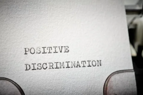 Positive discrimination text written with a typewriter. Stock Photos