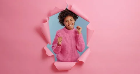 Positive ecstatic overjoyed dark skinned woman dances to music rhythmically Stock Footage 143171458