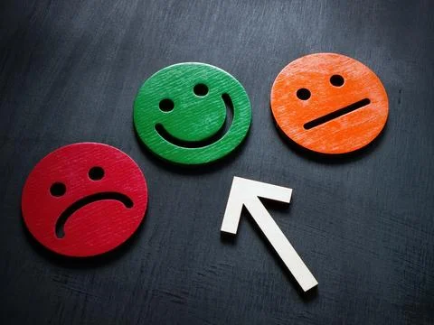 Positive emotion concept. The arrow points to a happy smiley. Stock Photos